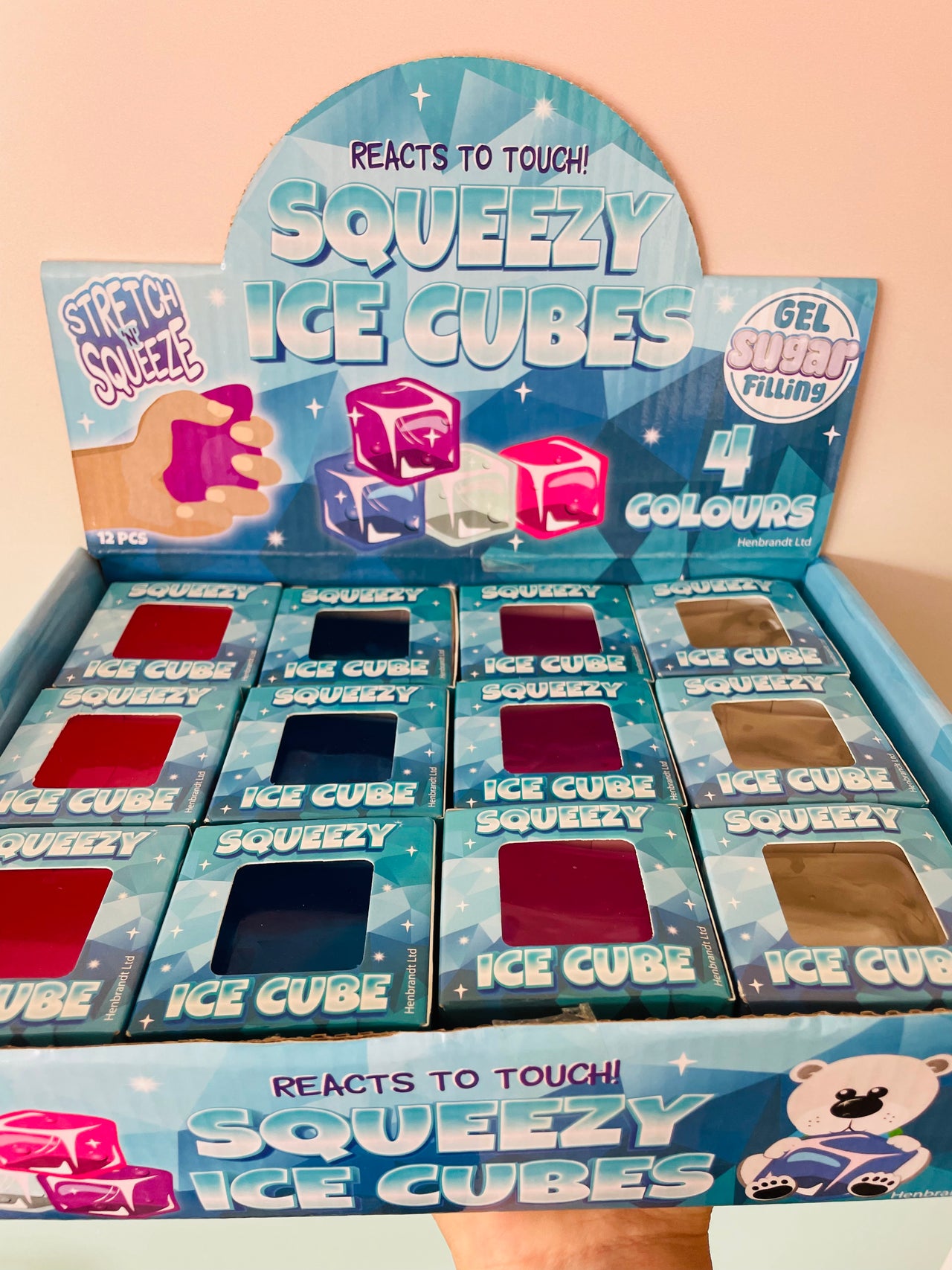 A retail display box of Squeezy Ice Cubes gel super filling ice cubes. The blue cardboard display box contains multiple small blue boxes of the ice cubes, each with a window showing the color of the gel inside.