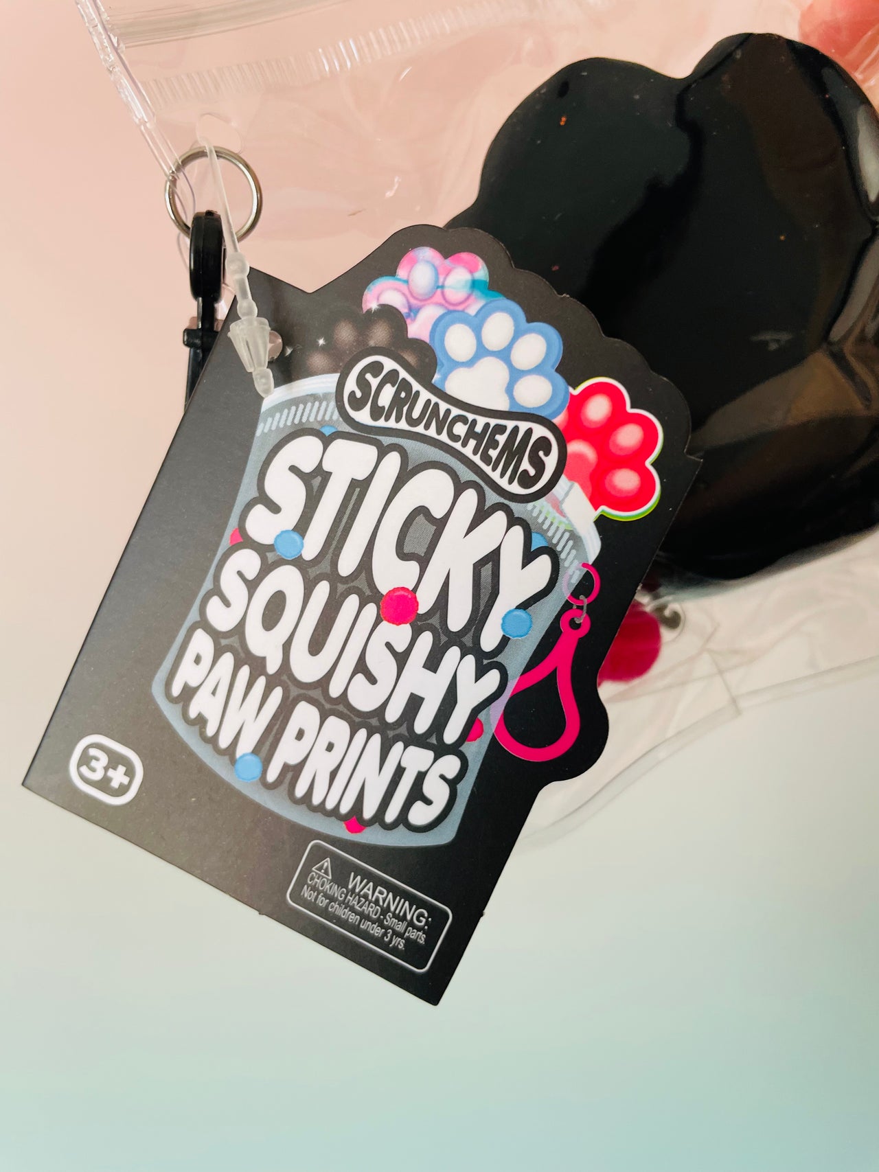 Close-up of Black Scrunchems Sticky Squishy Paw Print with glitter