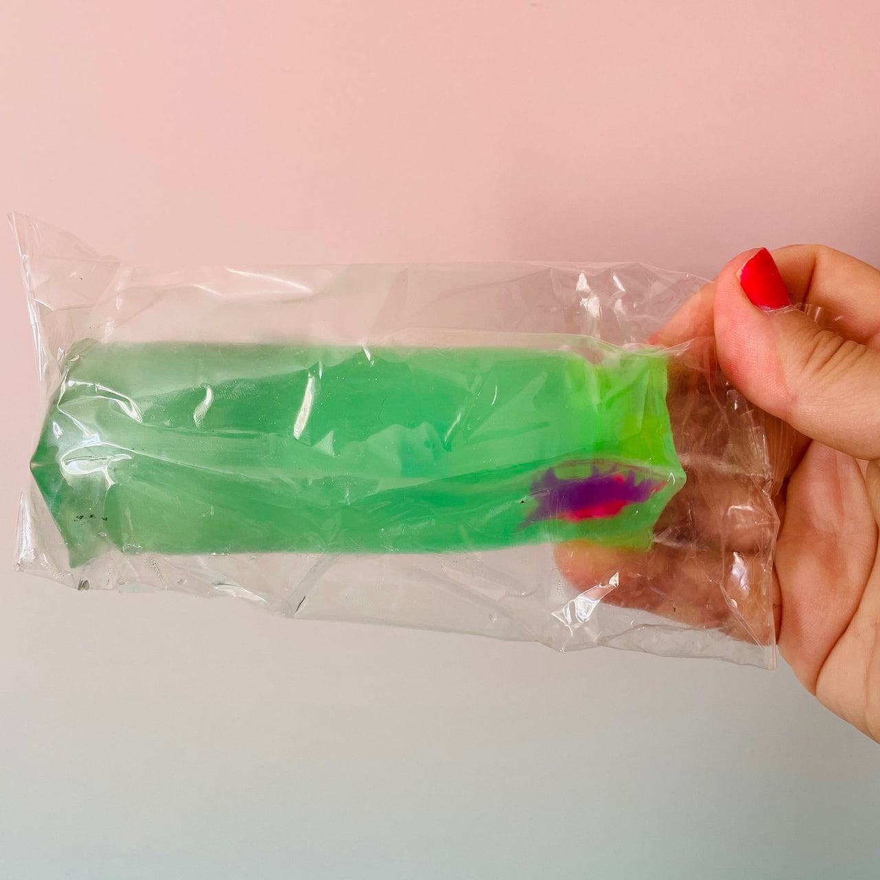 Green Dinosaur Slippery Snake sensory toy in retail packaging